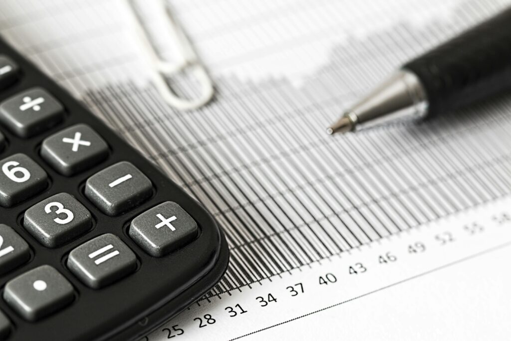 pexels photo 209224 209224 Close-up of a calculator and pen on a bar graph, representing finance and accounting.